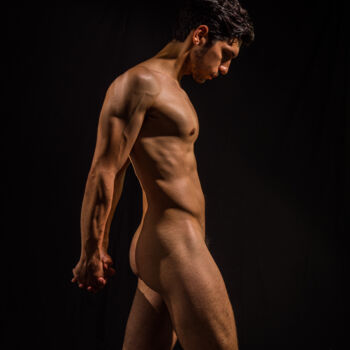 Naked man moving forward. Muscular tension in a male nude.
