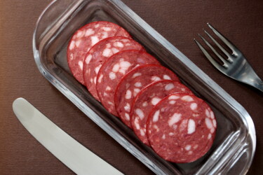 Fotografie getiteld "slices salami on a…" door Mrivserg, Origineel Kunstwerk, Digitale fotografie