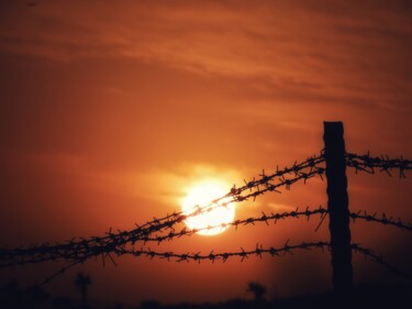 Photography titled "Sunset over barbed…" by Ravid Wolff, Original Artwork, Digital Photography