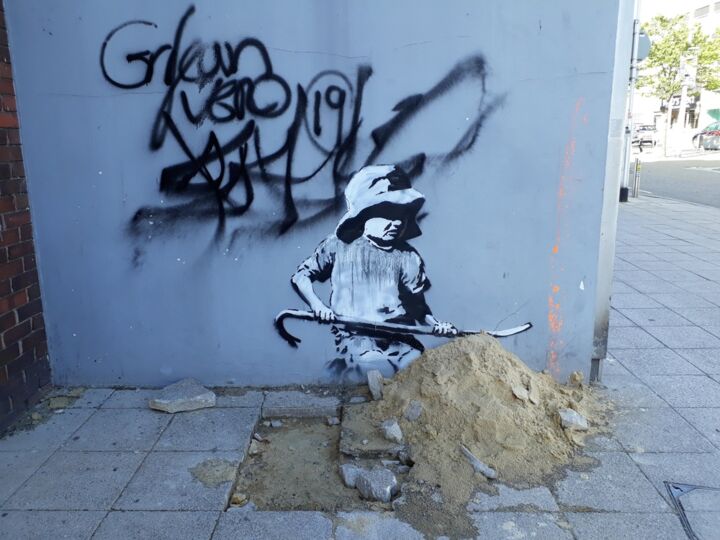A work by Banksy, torn from the wall by the owner of the building